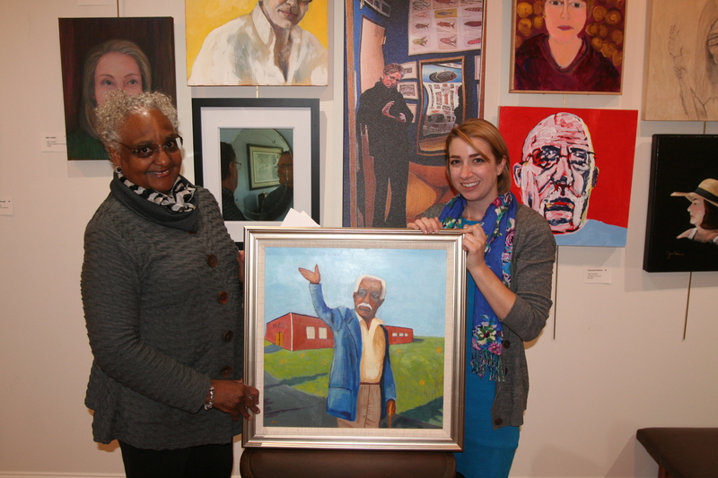 Artist Olaive Jones, left, donated her painting of Noble Prettyman to the Milton Historical Society. The painting shows Noble indicating where a sidewalk should be constructed in front of H.O. Brittingham Elementary School in Milton. Allison Schell, right, historical society executive director, said the painting, titled 'Put it There' is now part of the society's permanent collection. Jones said she wanted to capture Noble's personality and pay tribute to his leadership on issues affecting the quality of children’s educational experiences. BY HENRY J. EVANS JR.